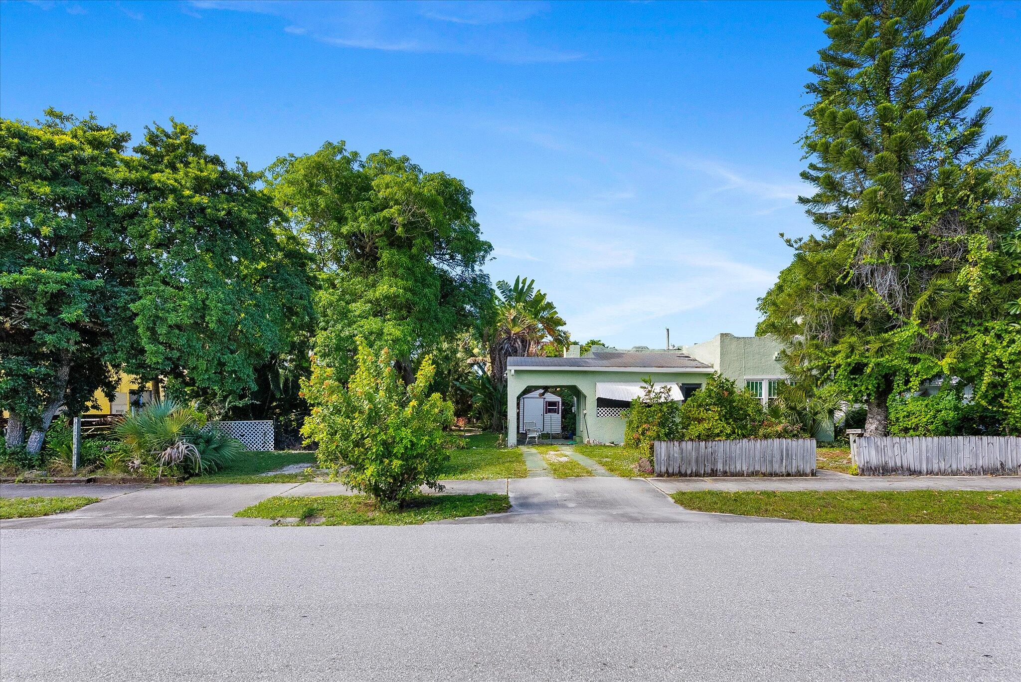 212 Southwest 2nd Avenue Delray Beach, FL 33444 - Photo 2 of 28 a view of swimming pool with plants and large trees