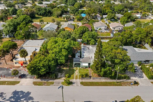 an aerial view of residential houses with yard