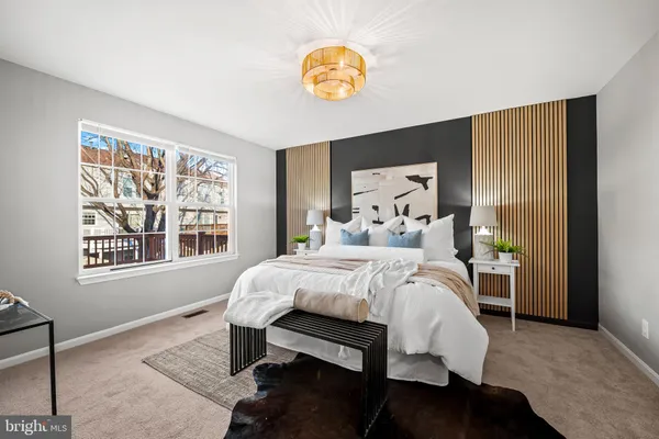 a spacious bedroom with a bed and a cabinets