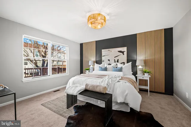 a spacious bedroom with a bed and a cabinets