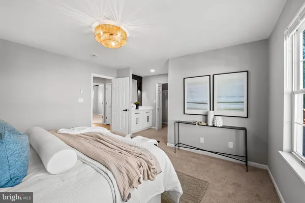 a en suite bathroom with a granite countertop sink and a mirror