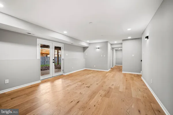 a view of a room with wooden floor