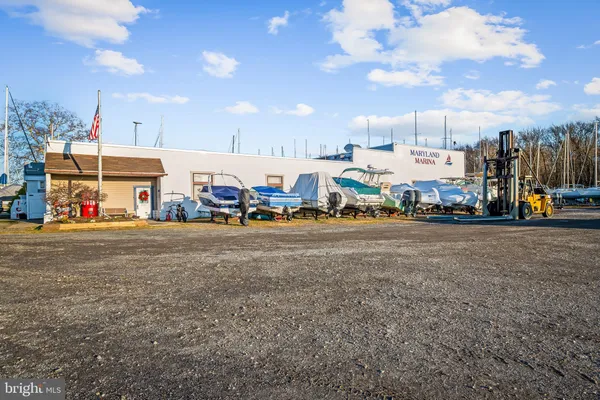 a view of a house with wooden deck next to a yard