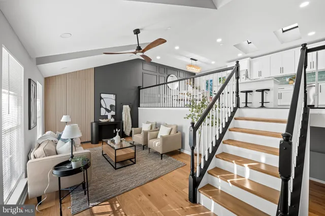 a living room with fireplace furniture and a wooden floor
