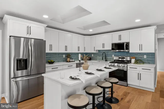 a kitchen with appliances a sink and cabinets