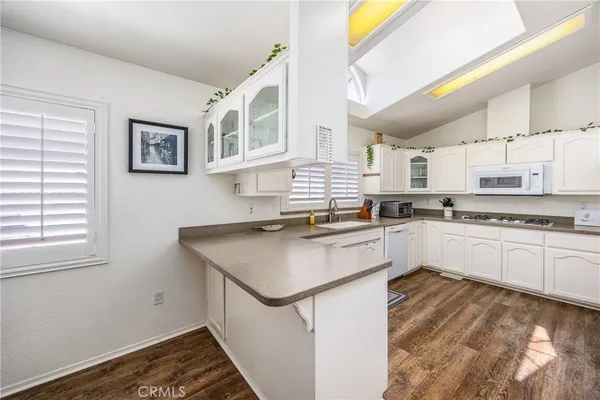a kitchen with stainless steel appliances granite countertop a stove and a sink