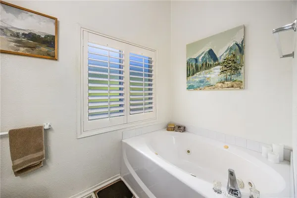 a bathroom with a bathtub and a window