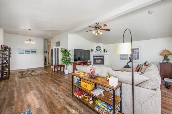 a living room with furniture flat screen tv and a fireplace