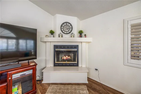 a living room with a fireplace and a flat screen tv