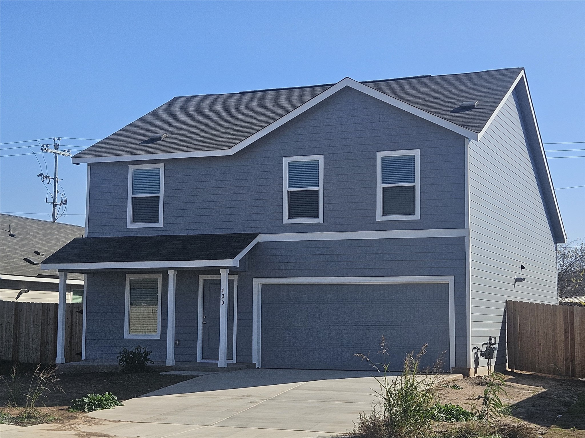 420 Drizzle Drive Lockhart, TX 78644 - Photo 1 of 1 a front view of a house with a garage