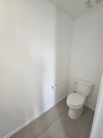 an empty room with an entryway and window