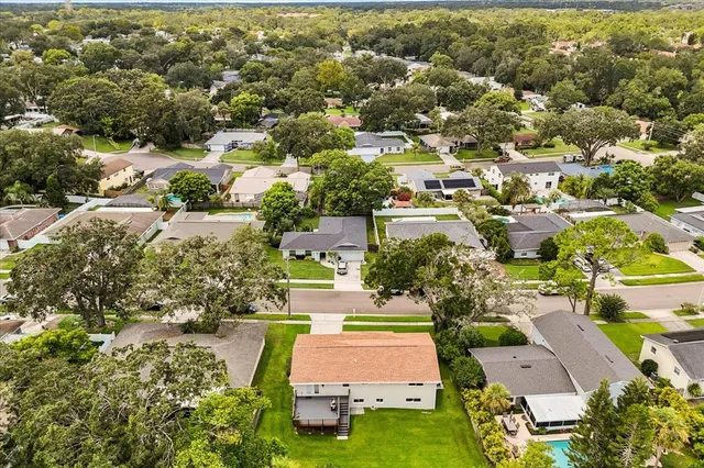 an aerial view of residential houses with yard and swimming pool