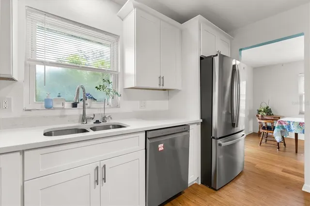 a kitchen with appliances cabinets and a window