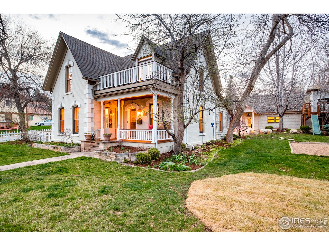 2303 Bluff Street Boulder, CO 80304 - Photo 2 of 40 a view of a white house next to a yard and a large tree