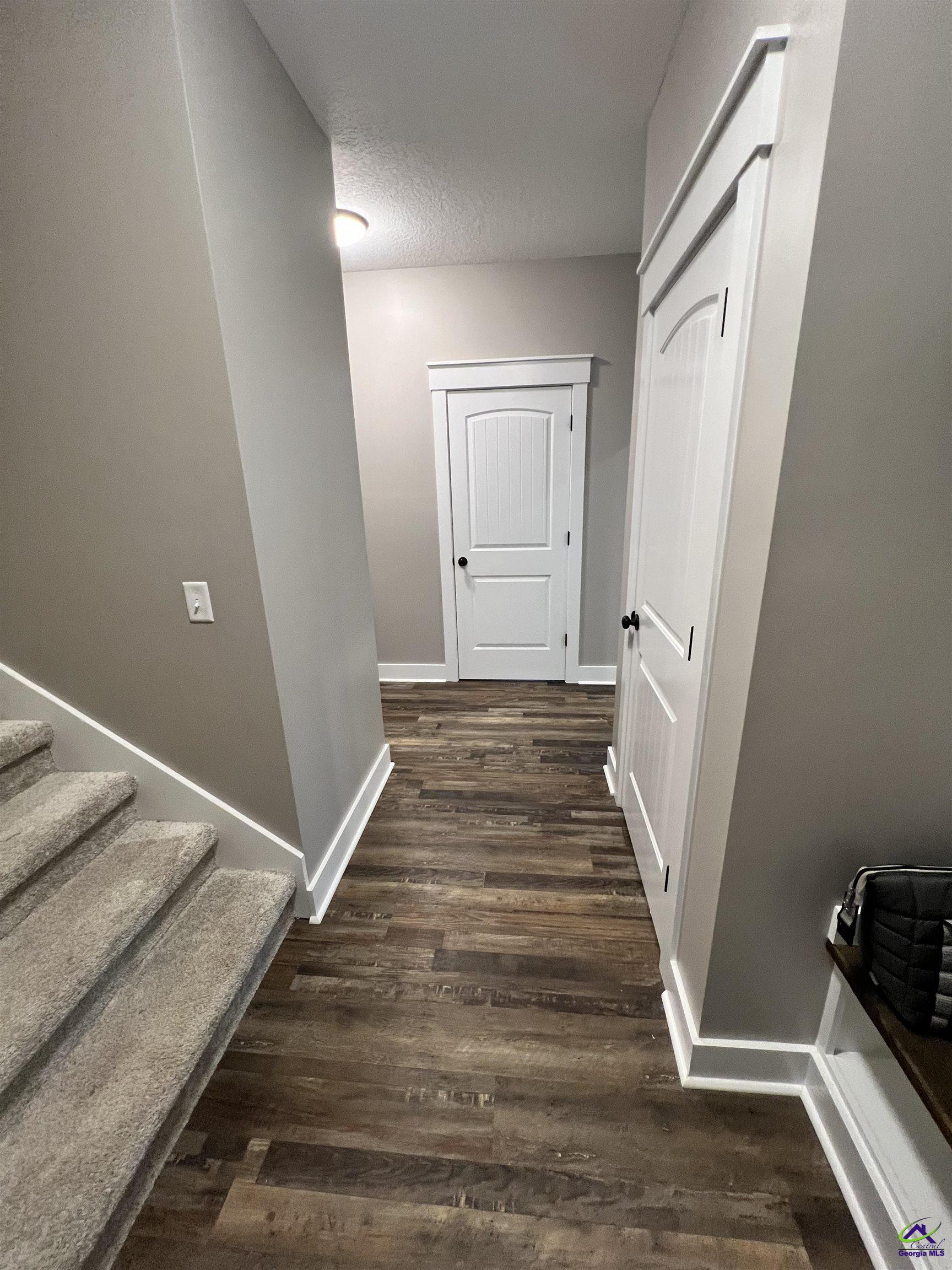 2203 Old Macon Road Montrose, GA 31065 - Photo 14 of 64 a view of a hallway with wooden floor and staircase