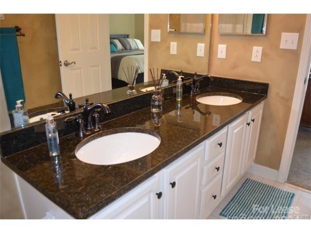 1313 Torrence Circle Davidson, NC 28036 - Photo 13 of 20 a bathroom with a sink double vanity and a mirror