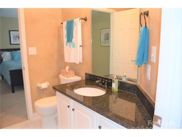 1313 Torrence Circle Davidson, NC 28036 - Photo 15 of 20 a bathroom with a granite countertop sink and a mirror