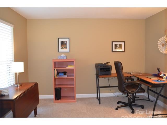 1313 Torrence Circle Davidson, NC 28036 - Photo 16 of 20 a living room with furniture and a desk