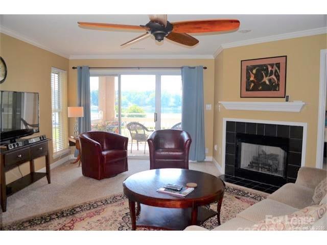 1313 Torrence Circle Davidson, NC 28036 - Photo 7 of 20 a living room with furniture a fireplace and a flat screen tv