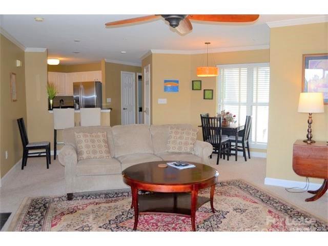 1313 Torrence Circle Davidson, NC 28036 - Photo 8 of 20 a living room with furniture a table and kitchen view