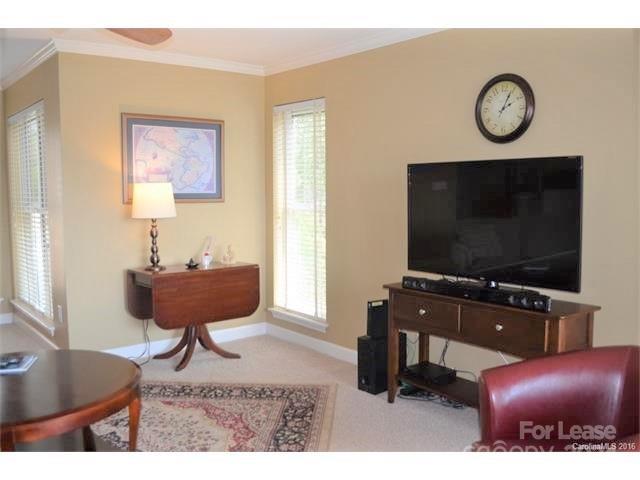 1313 Torrence Circle Davidson, NC 28036 - Photo 9 of 20 a living room with furniture and a flat screen tv