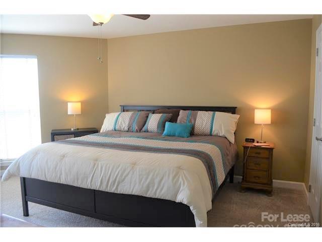 1313 Torrence Circle Davidson, NC 28036 - Photo 10 of 20 a bedroom with a bed and a night stand