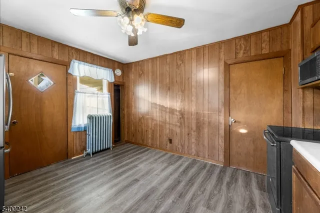 a view of hallway with a ceiling fan