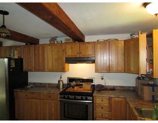 61 Searle Road Huntington, MA 01050 - Photo 11 of 16 a kitchen with a stove a sink and a microwave