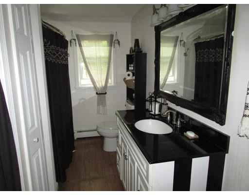 61 Searle Road Huntington, MA 01050 - Photo 13 of 16 a bathroom with a sink a toilet a mirror and vanity