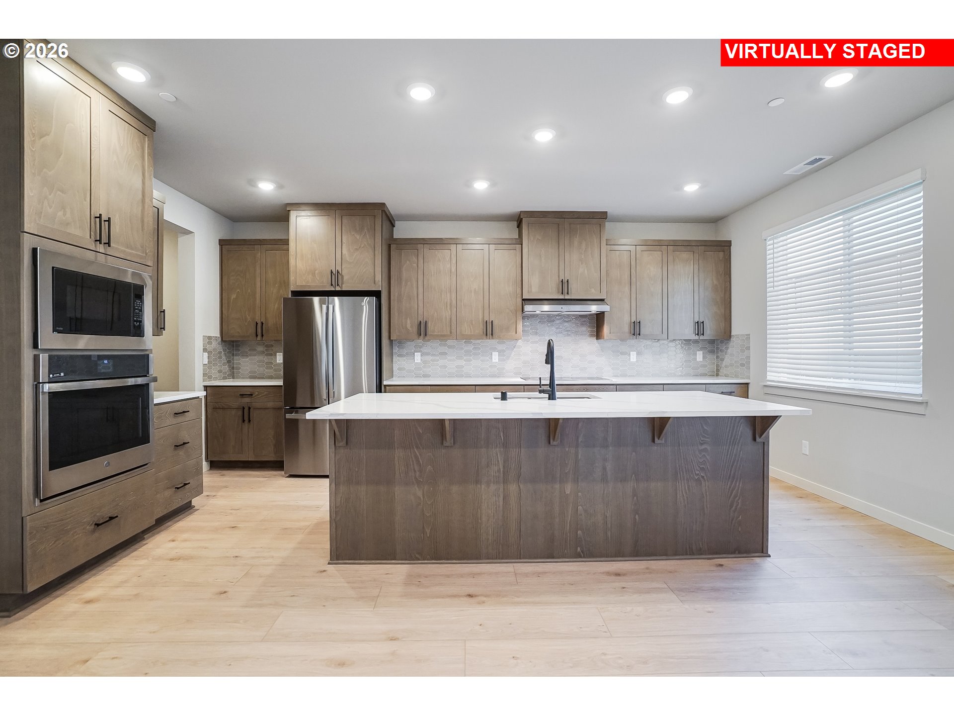 5297 North 87th Avenue Camas, WA 98607 - Photo 5 of 44 a large kitchen with kitchen island a sink stainless steel appliances and cabinets