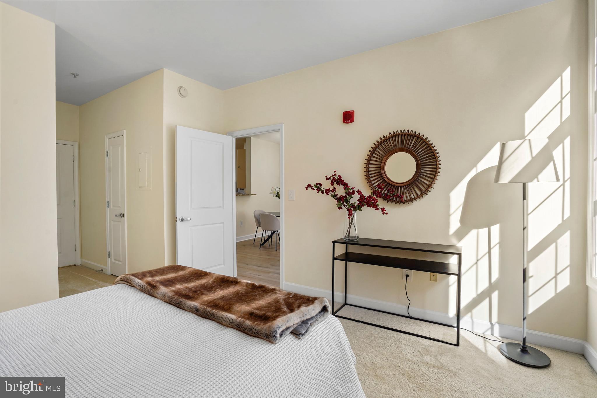 1111 25th Street Northwest, Unit 403 Washington, DC 20037 - Photo 4 of 24 a bedroom with a bed and a chandelier