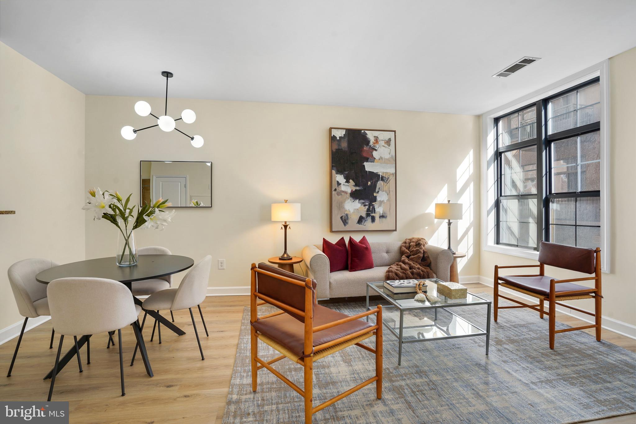 1111 25th Street Northwest, Unit 403 Washington, DC 20037 - Photo 6 of 24 a living room with furniture and a chandelier