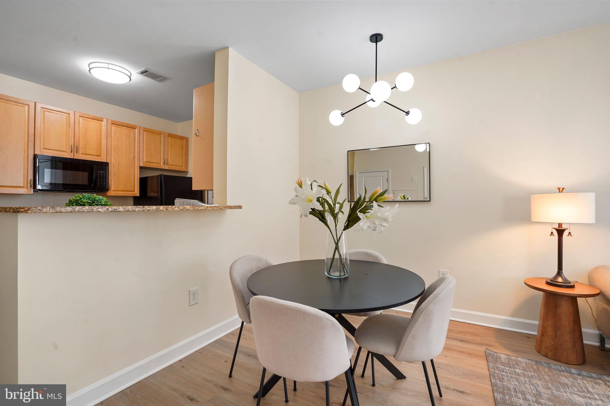 1111 25th Street Northwest, Unit 403 Washington, DC 20037 - Photo 7 of 24 a dining room with furniture and chandelier