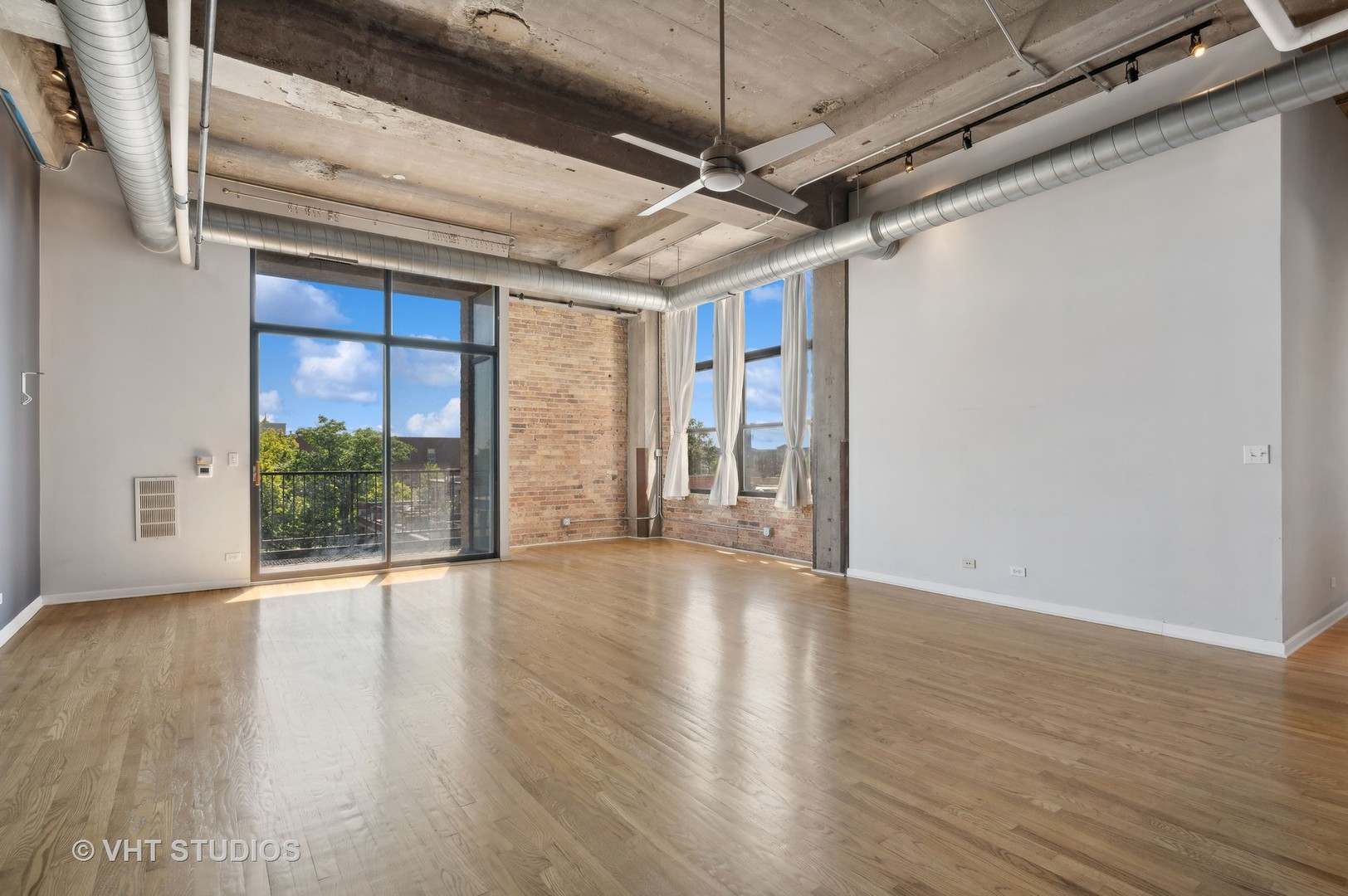 1820 North Spaulding Avenue, Unit 403 Chicago, IL 60647 - Photo 3 of 17 a view of an empty room with wooden floor and a window