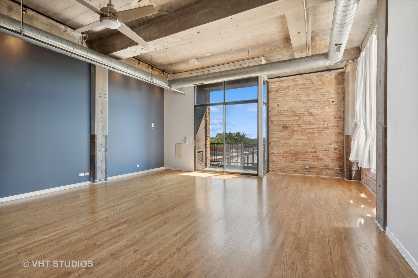 1820 North Spaulding Avenue, Unit 403 Chicago, IL 60647 - Photo 5 of 17 a view of an empty room with wooden floor and a window