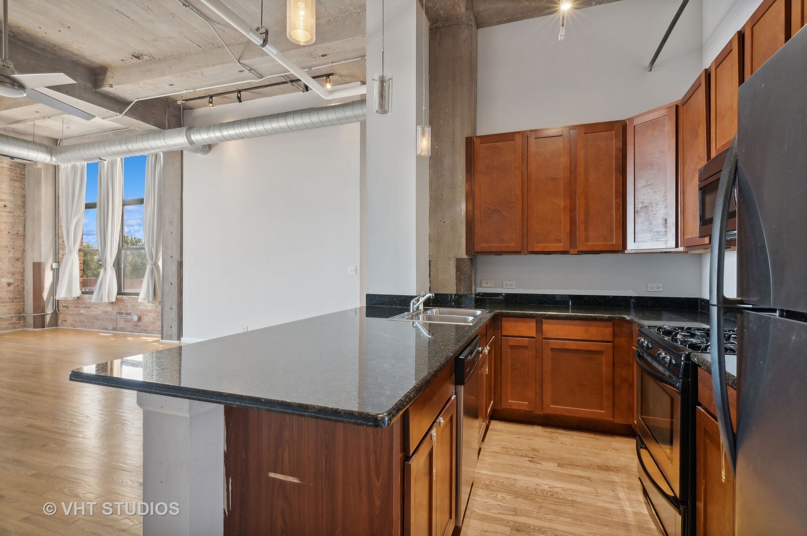 1820 North Spaulding Avenue, Unit 403 Chicago, IL 60647 - Photo 6 of 17 a kitchen with stainless steel appliances granite countertop a sink and a refrigerator