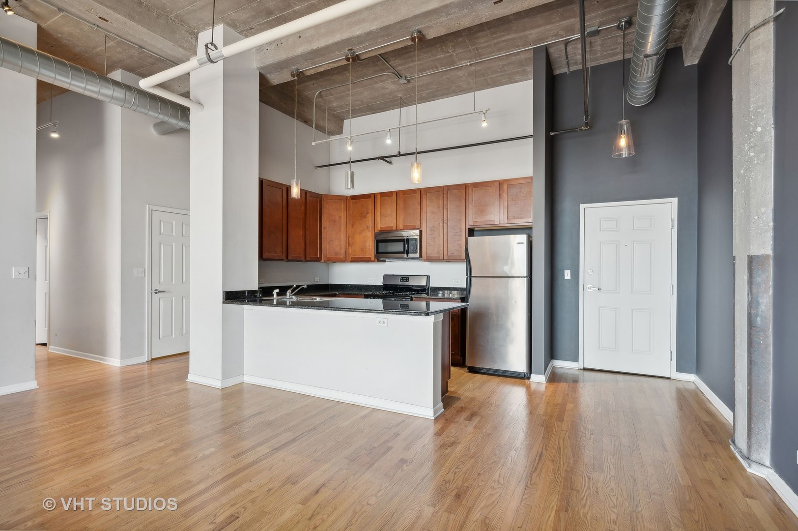 1820 North Spaulding Avenue, Unit 403 Chicago, IL 60647 - Photo 7 of 17 a kitchen with stainless steel appliances granite countertop a refrigerator and a stove top oven