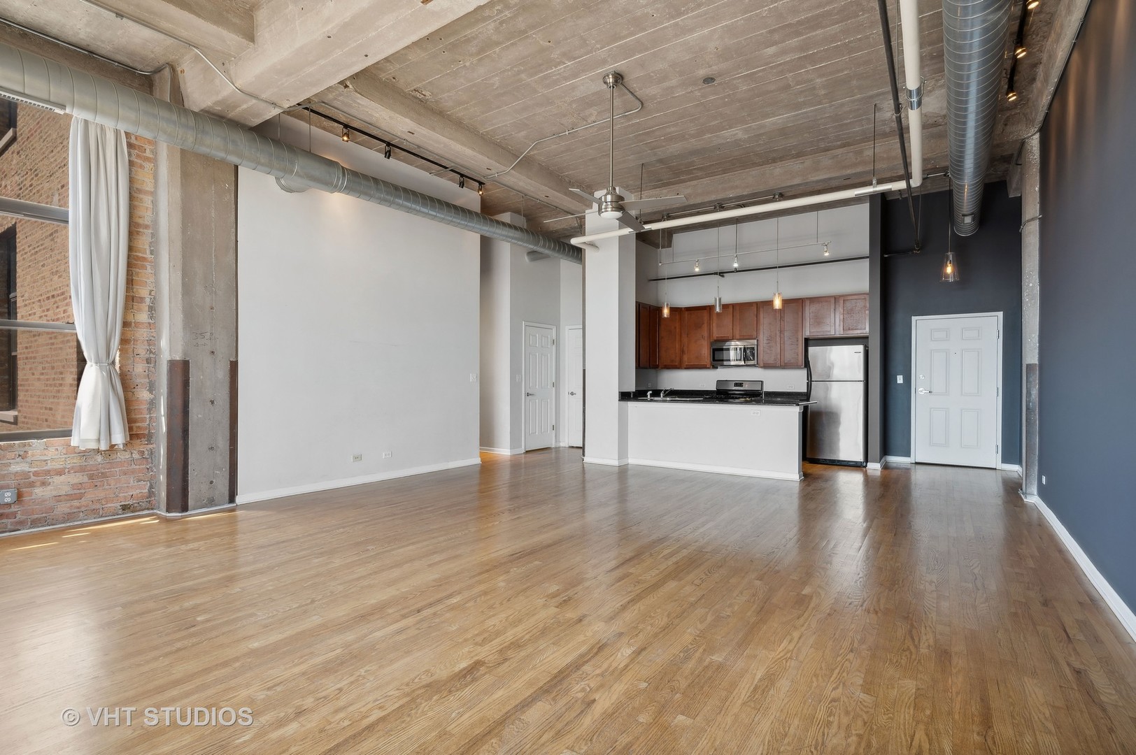 1820 North Spaulding Avenue, Unit 403 Chicago, IL 60647 - Photo 8 of 17 a view of an empty room with wooden floor and a window