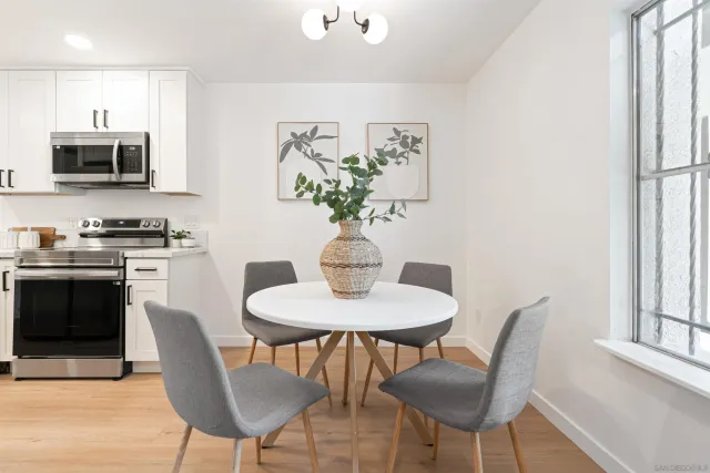 a dining room with furniture and a potted plant