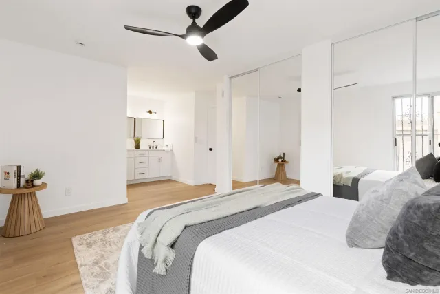 a bathroom with a double vanity sink mirror and bathtub