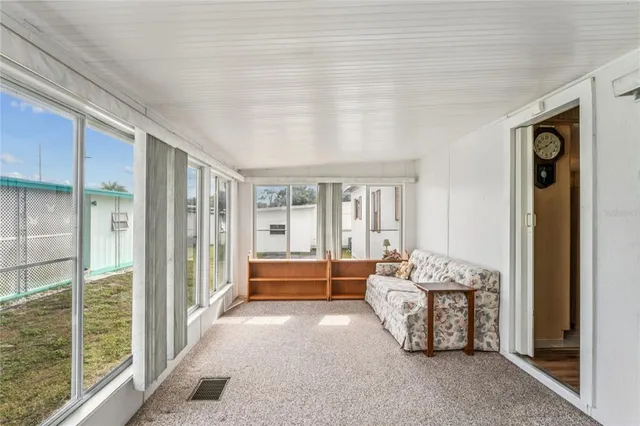 a bedroom with furniture and large windows