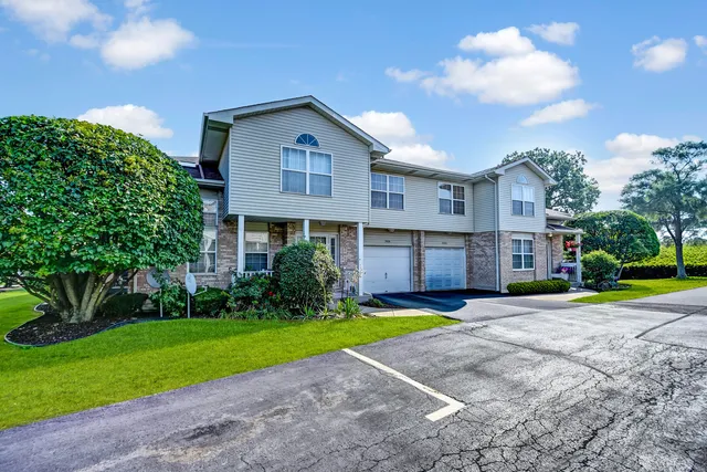 a view of a house with a yard and plants