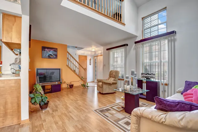 a living room with furniture stairs and a window