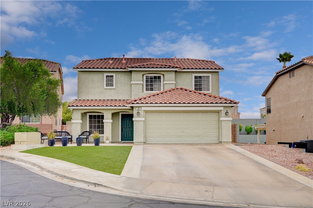 197 Kings Canyon Court Henderson, NV 89012 - Photo 1 of 39 Mediterranean / spanish-style house with driveway, stucco siding, an attached garage, a front yard, and a tiled roof