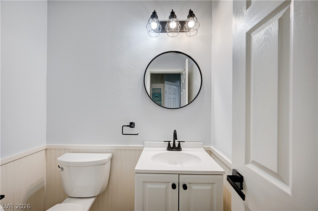 197 Kings Canyon Court Henderson, NV 89012 - Photo 17 of 39 Bathroom with vanity and a wainscoted wall