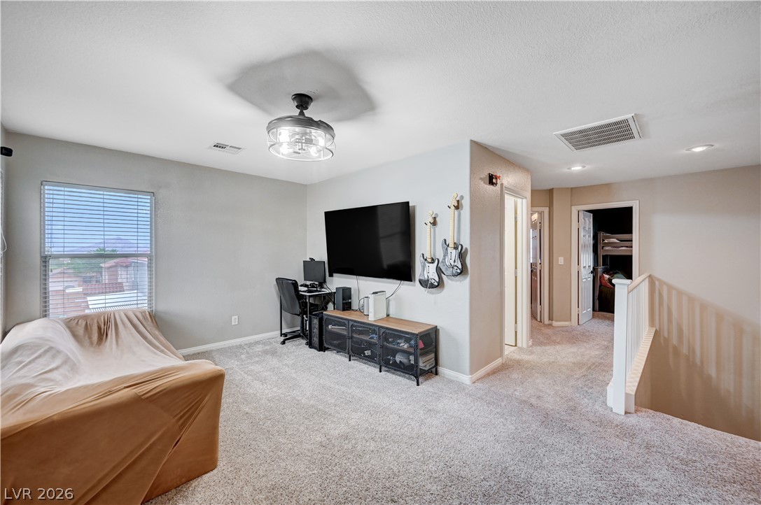 197 Kings Canyon Court Henderson, NV 89012 - Photo 20 of 39 Living room with carpet floors and baseboards