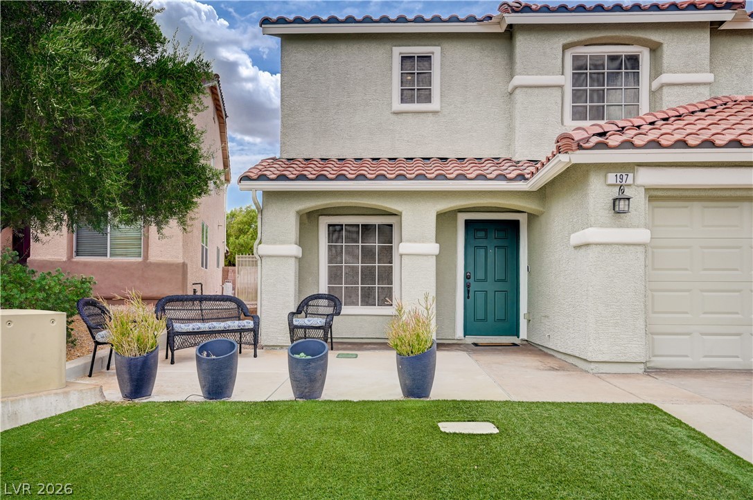 197 Kings Canyon Court Henderson, NV 89012 - Photo 2 of 39 Mediterranean / spanish-style house featuring a tile roof, stucco siding, a garage, and a front lawn