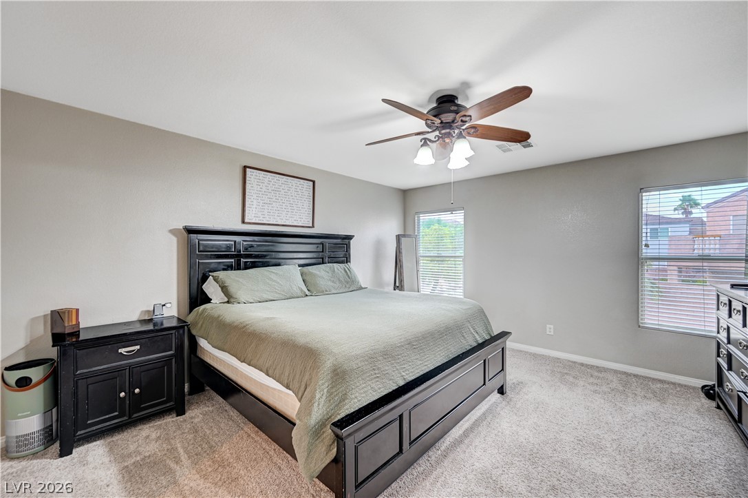 197 Kings Canyon Court Henderson, NV 89012 - Photo 22 of 39 Primay Bedroom with light carpet and a ceiling fan