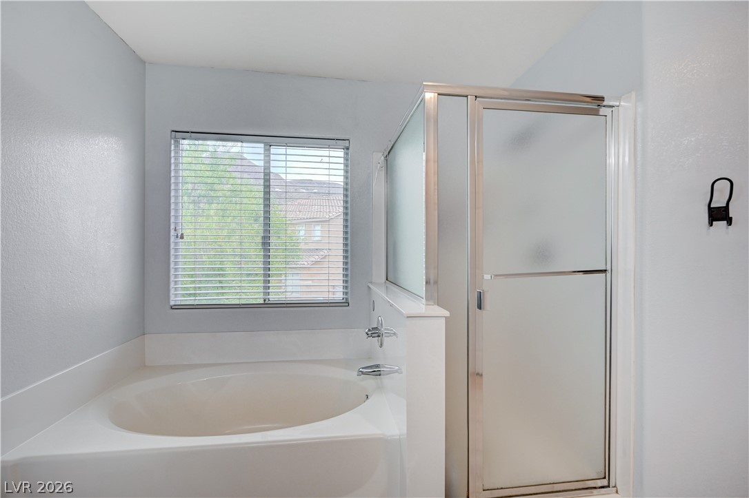 197 Kings Canyon Court Henderson, NV 89012 - Photo 26 of 39 Primary bathroom featuring healthy amount of natural light, a shower stall, and a garden tub
