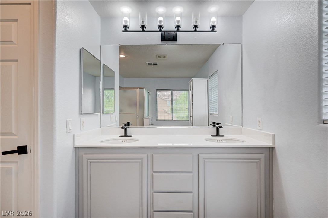 197 Kings Canyon Court Henderson, NV 89012 - Photo 27 of 39 Bathroom featuring a stall shower and double vanity